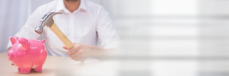 Digital composite of Man with a hammer and a piggy bankの写真素材