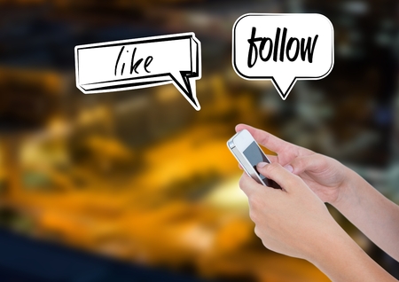 Digital composite of Holding phone and Like Blog Follow chat bubbles over cityの写真素材