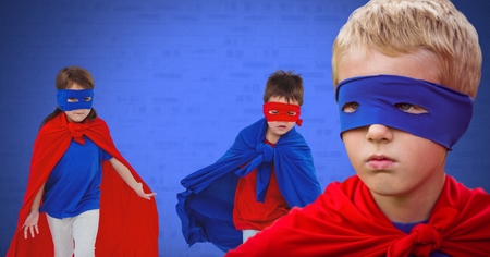 Digital composite of Superhero kids with blank blue backgroundの写真素材