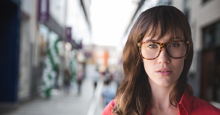 Digital composite of Business woman standing against street backgroundの写真素材