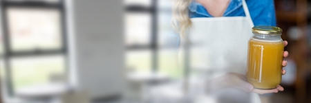 Digital composite of Small business owner woman holding a jarの写真素材