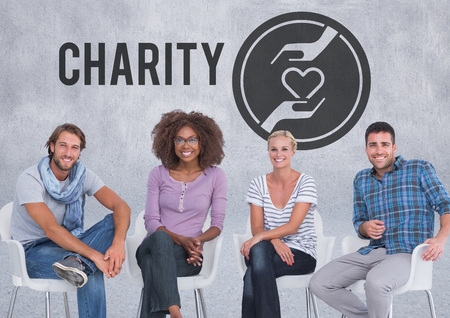 Digital composite of Group of people sitting in front of charity hands with heartの写真素材