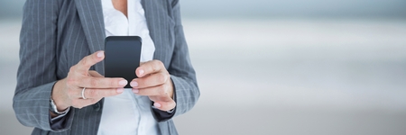 Digital composite of Business woman using a phoneの写真素材