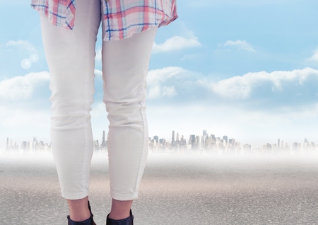 Digital composite of Woman's legs in front of city landscapeの写真素材