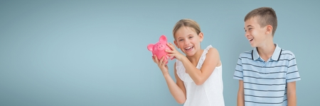 Digital composite of Happy boy and happy girl holding a piggy bank against blue backgroundの写真素材