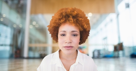 Digital composite of Business woman standing against office background