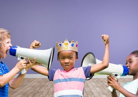 Digital composite of kids with crown with megaphones in blank room backgroundの写真素材