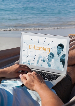 Digital composite of Man using a computer with e-learning information in the screenの写真素材