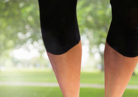 Digital composite of Athletic slim legs in parkの写真素材