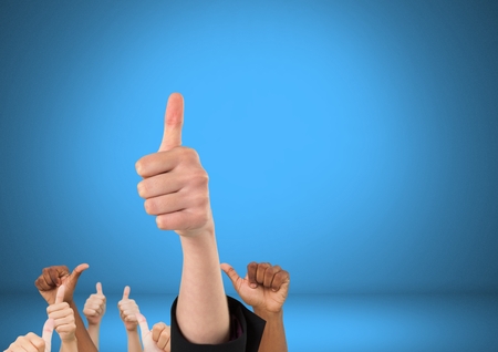 Digital composite of Hands with thumbs up in front of blue backgroundの写真素材