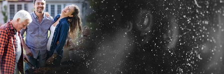 Digital composite of Family laughing next to bbq and black rain transitionの写真素材