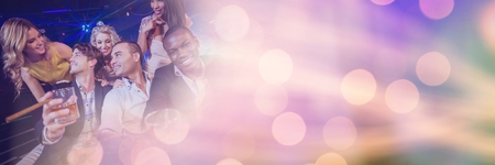 Digital composite of People having fun celebration party with sparkling lights bokeh transitionの写真素材