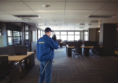 Digital composite of security guard guarding the officeの写真素材