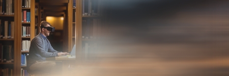 Digital composite of Man in virtual reality headset in library and blurry sunset transitionの写真素材