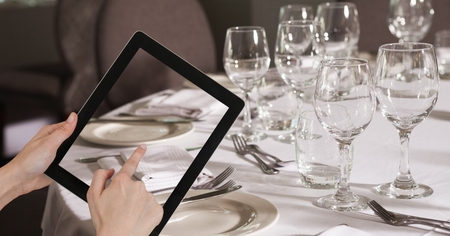 Digital composite of Hands taking picture with tablet PC in bar pubの写真素材