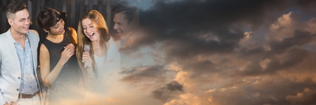Digital composite of People having fun celebration party with sky clouds transitionの写真素材