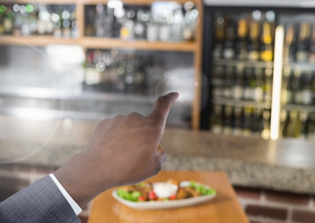 Digital composite of Hand pointing in air in barの写真素材