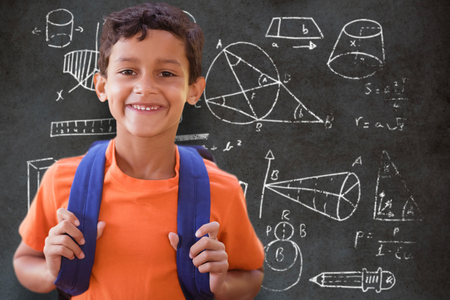 Portrait of smiling boy  against close-up of blackboardの写真素材