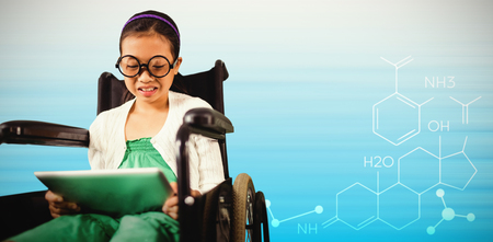 Young girl looking at digital tablet against composite image of abstract backgroundsの写真素材