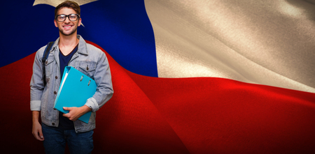 Student smiling at camera in library against digitally generated chile national flagの写真素材