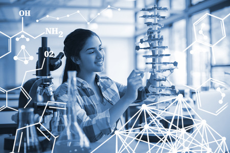 Kids doing a chemical experiment in laboratory against attentive schoolgirl experimenting molecule model in laboratoryの写真素材
