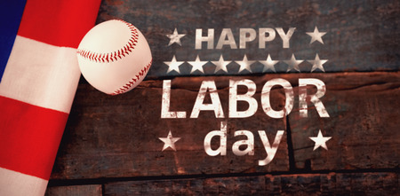 Poster of happy labor day text against baseball ball and american flag on tableの写真素材
