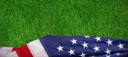 Close-up of American flag against closed up view of grassの写真素材