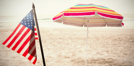Flare against beach umbrella at tropical sand beachの写真素材