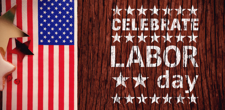 Poster of celebrate labor day text against american flag and star shape decoration arranged on wooden tableの写真素材