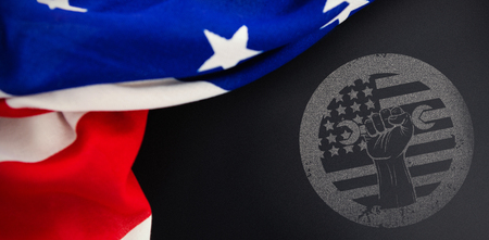 Cropped hand holding tool and american flag on red poster against american flag on empty slateの写真素材