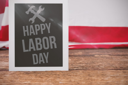 Flare against american flag and digital tablet on tableの写真素材