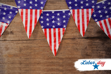 Digital composite image of happy labor day text with star shape against american flag buntings on...