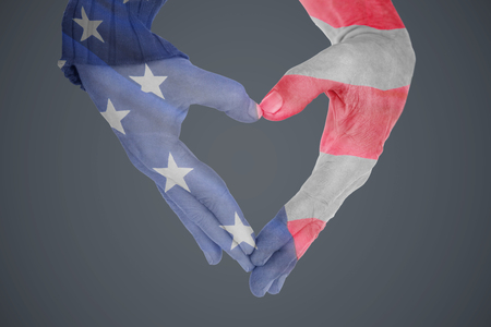 Close up of hands forming heart against close-up of us flagの写真素材