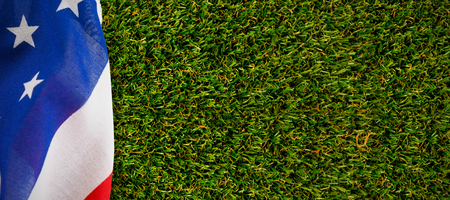 Close-up of American flag against close-up of grass mat