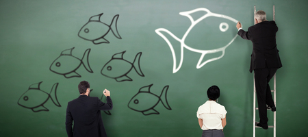Business team writing against green chalkboardの写真素材