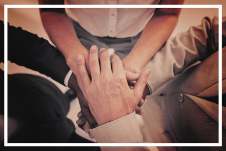 High angle view of business people gathering their hands togetherの写真素材