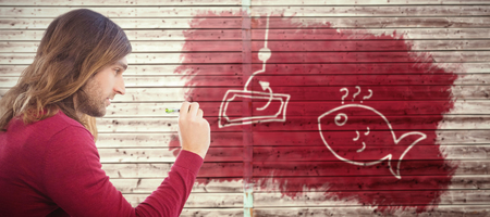 Hipster writing on sticky note stuck on glass against digitally generated grey wooden planksの写真素材