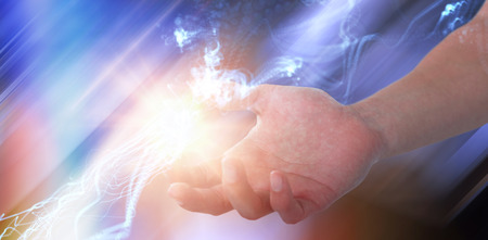 Hand of man pretending to hold an invisible object against abstract glowing black background