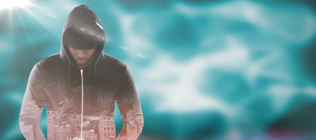 Spy in black hoodie against abstract pattern on wallの写真素材