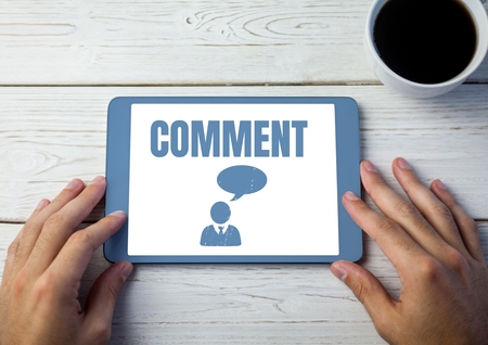 Digital composite of Comment text and chat graphic on tablet screen with hands