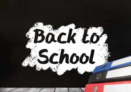 Digital composite of Folders on Desk foreground with blackboard graphics of Back to school