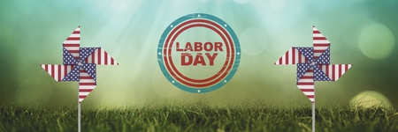 Digital composite of labor day text and USA wind catchers in front of grass and sky