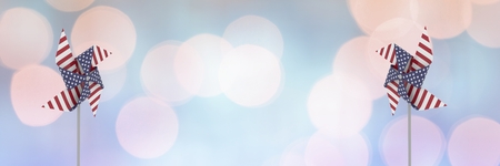 Digital composite of USA wind catchers in front of sparkling bokeh lights