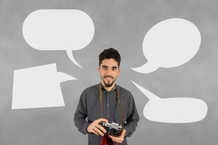 Digital composite of Photographer man with speech bubbles against grey backgroundの写真素材