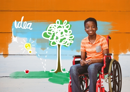 Digital composite of Disabled boy in wheelchair with idea colorful drawingsの写真素材