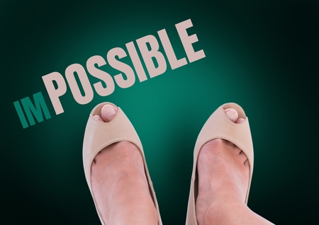 Digital composite of Impossible text and Beige shoes on feet with green background