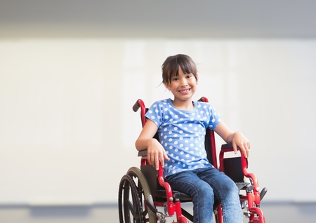 Digital composite of Disabled girl in wheelchair in schoolの写真素材