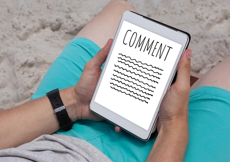 Digital composite of Comment text and writing graphic on tablet screen with handsの写真素材