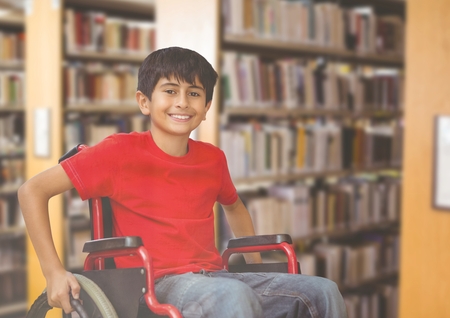 Digital composite of Disabled boy in wheelchair in school libraryの写真素材
