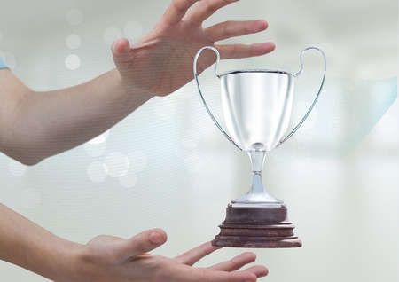 Digital composite of Woman with a trophy on handsの写真素材
